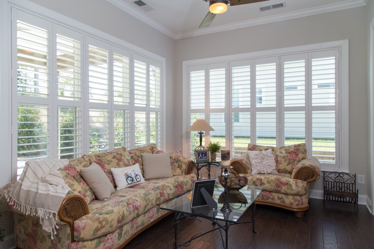 Airy sunroom with plantation shutters in Detroit.